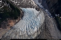 A glacier created in the high peaks of the St. Elias Mountains (Alaska). Over time, falling snow piles up in mountain recesses, and ever so slowly the weight of accumulating snow compact lower layers into dense ice. When the ice becomes thick enough, it starts to remove downhill. This shot was made on a flight over Glacier Bay National Park For more Alaska and US web galleries: www.michelhammann-photography.com 