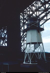 Located close to the bottom of a main pillar and the utility's office building , this disused searchlight stood high among the Bridge's Museum outer exhebits 