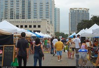 Austin's Farmers Market at Republic Square. The highrise on the left is 360 Condominiums. Behind that is The Spring Condominiums. The building on the right is The Monarch Apartments. Its crown is supposed to symbolize the wings of a butterfly 