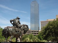 A Cow Boy, part of a huge bronze sculpture, faces downtown Dallas